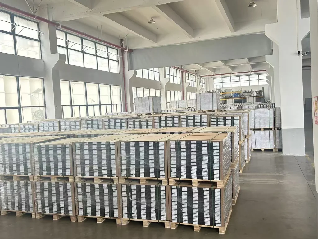 Palletized flooring inventory in a factory warehouse, ready for order handling and shipment.